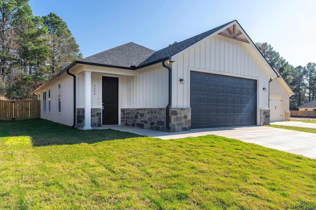 view of front of home with a front yard and a garage