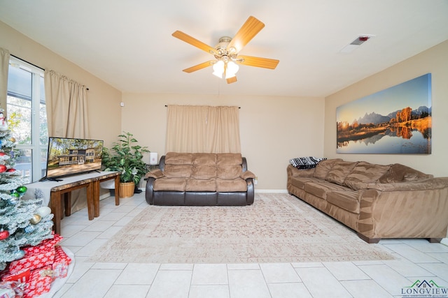 living room featuring ceiling fan and light tile patterned flooring