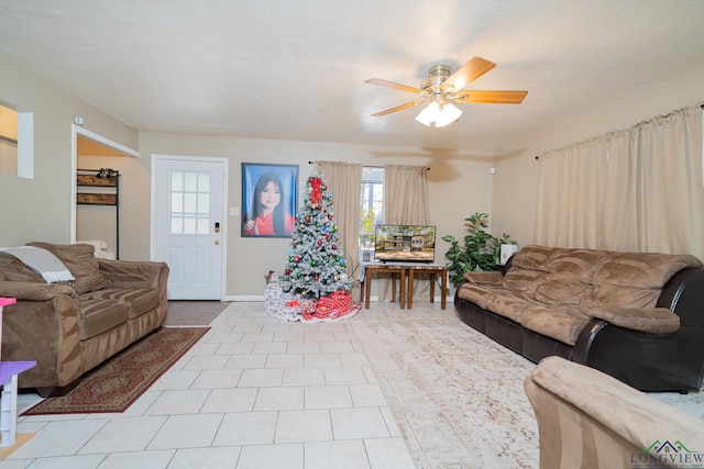 living room with light tile patterned floors and ceiling fan