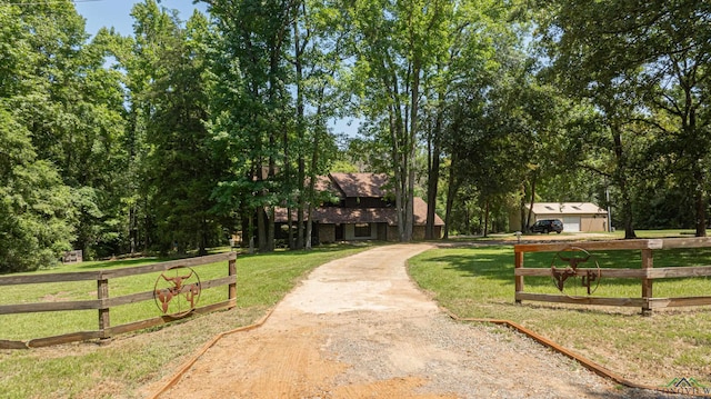 view of home's community with a rural view and a yard