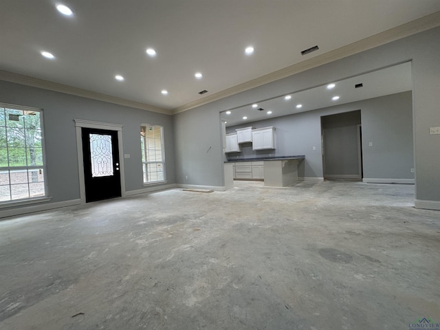 495 Lake Gladewater Rd, Gladewater, TX 75647 - unfurnished living room with ornamental molding, concrete floors, and recessed lighting