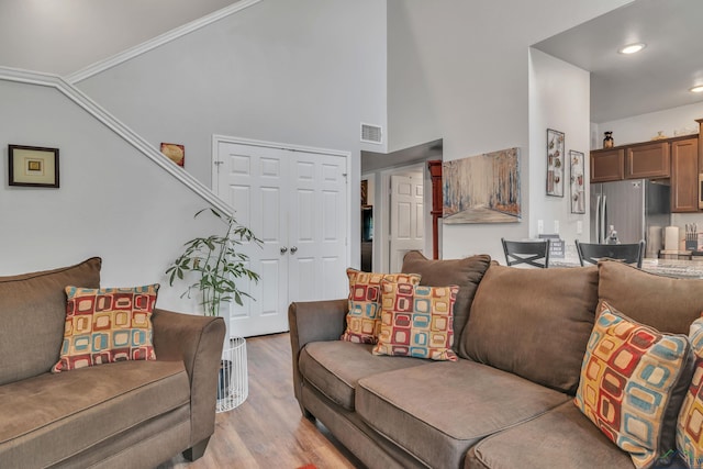 204 Hurley Ave, Gladewater, TX 75647 - living area featuring vaulted ceiling, recessed lighting, crown molding, light wood-style floors, and visible vents