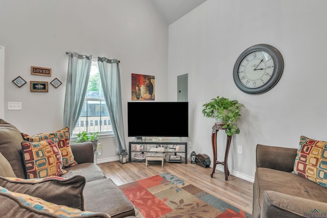 204 Hurley Ave, Gladewater, TX 75647 - living area featuring high vaulted ceiling, baseboards, and wood finished floors