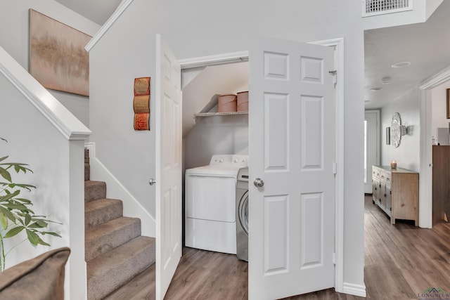 204 Hurley Ave, Gladewater, TX 75647 - laundry area featuring washer / clothes dryer, laundry area, wood finished floors, and visible vents