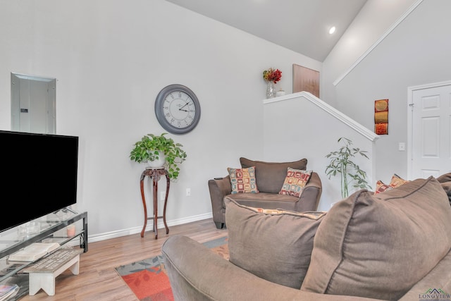204 Hurley Ave, Gladewater, TX 75647 - living area with baseboards, electric panel, stairway, wood finished floors, and high vaulted ceiling