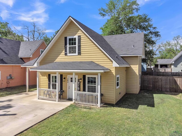 204 Hurley Ave, Gladewater, TX 75647 - bungalow-style house featuring roof with shingles, covered porch, a front yard, and fence