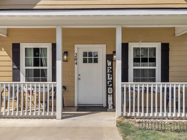 204 Hurley Ave, Gladewater, TX 75647 - doorway to property featuring covered porch
