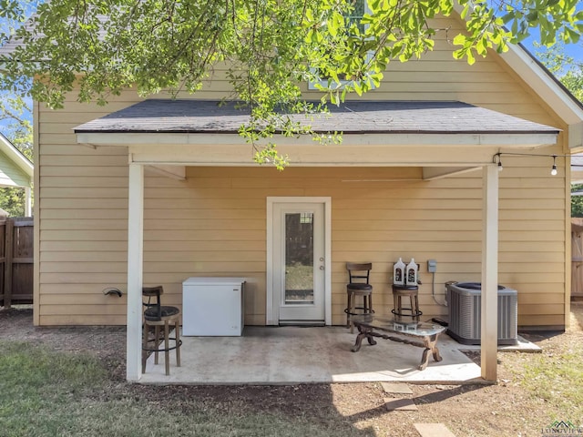 204 Hurley Ave, Gladewater, TX 75647 - rear view of property featuring central AC, fence, a shingled roof, and a patio area