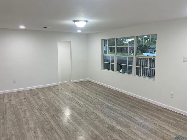 unfurnished room featuring wood finished floors and baseboards