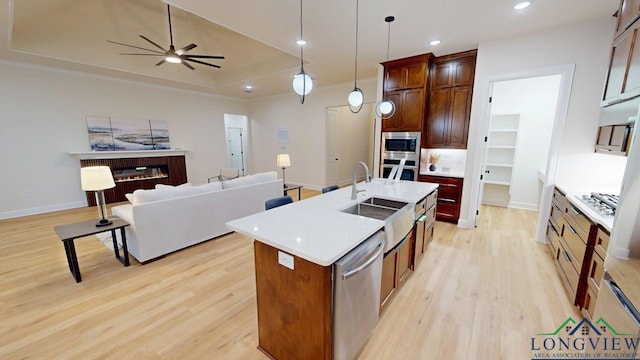 2509 Windmill Ln, Longview, TX 75601 - kitchen featuring appliances with stainless steel finishes, open floor plan, light wood-style floors, a ceiling fan, and recessed lighting