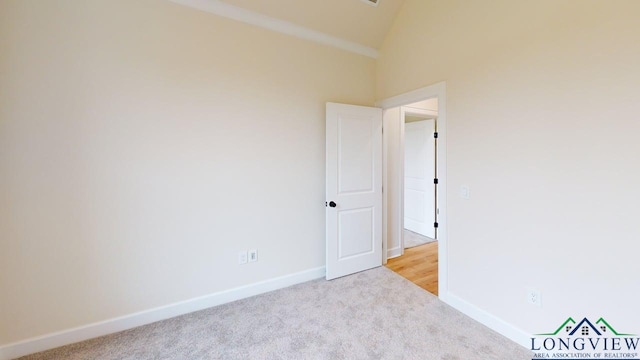 2509 Windmill Ln, Longview, TX 75601 - carpeted spare room featuring baseboards and high vaulted ceiling