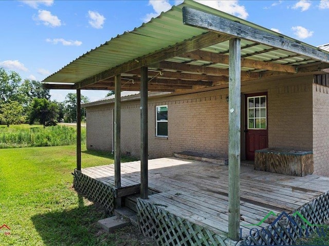 wooden terrace featuring a yard