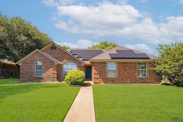 1505 Leach St, Kilgore, TX 75662 - single story home featuring roof with shingles, brick siding, a front lawn, and solar panels