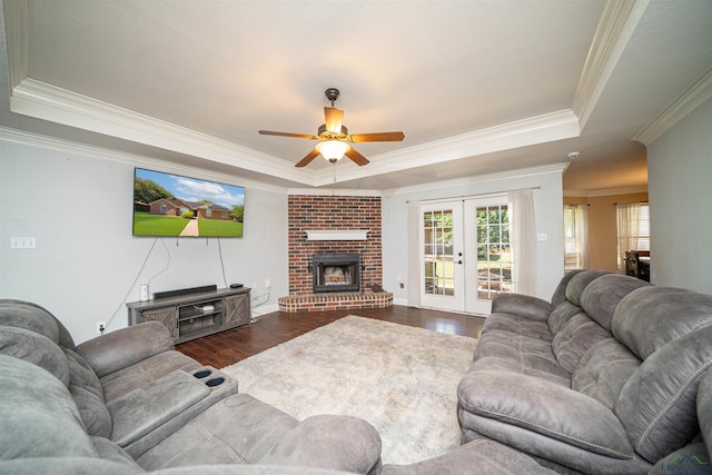 1505 Leach St, Kilgore, TX 75662 - living room with a tray ceiling, french doors, dark wood-type flooring, crown molding, and a ceiling fan