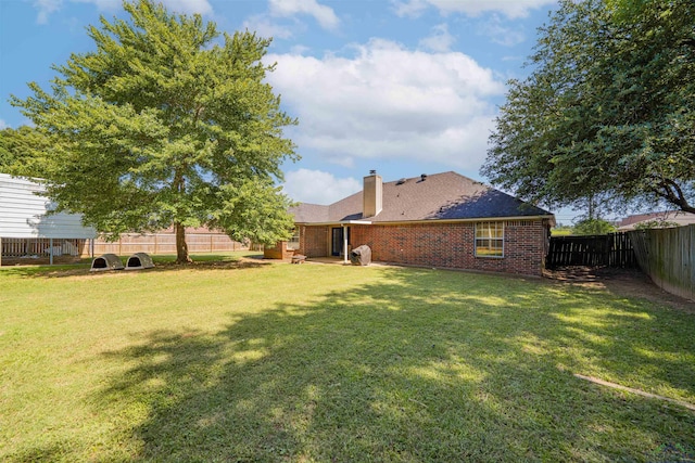 1505 Leach St, Kilgore, TX 75662 - back of house featuring a chimney and brick siding