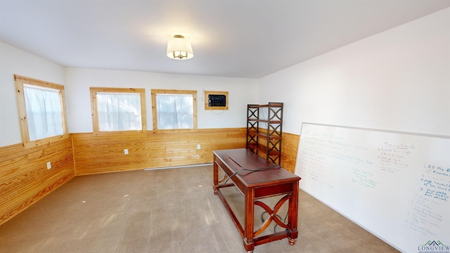 carpeted office featuring wooden walls