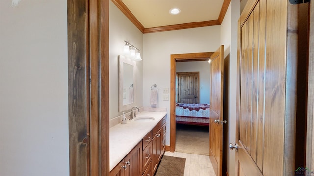 bathroom with crown molding and vanity