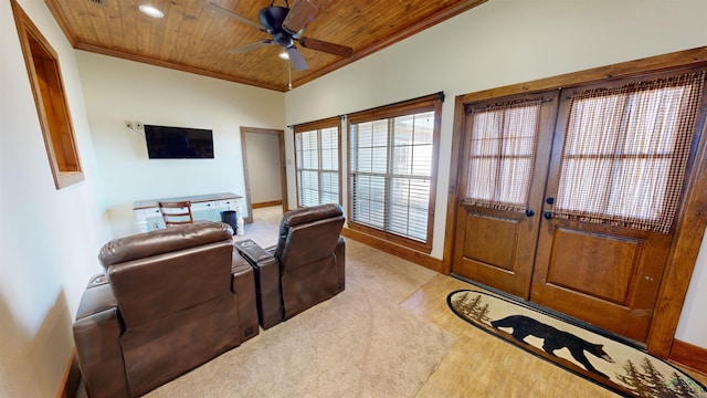 living room with wood ceiling, ceiling fan, and ornamental molding