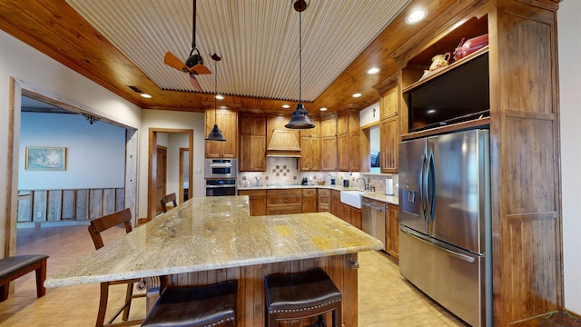 kitchen with hanging light fixtures, appliances with stainless steel finishes, wooden ceiling, and a kitchen bar