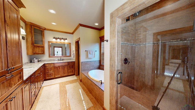 bathroom with plus walk in shower, ornamental molding, and vanity