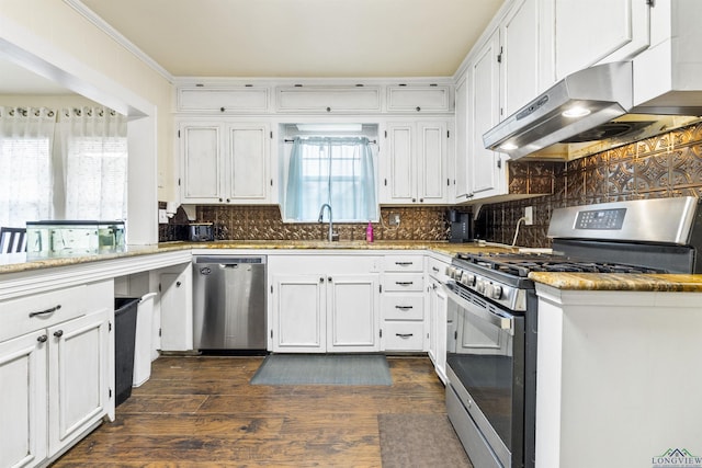 kitchen with backsplash, white cabinetry, and stainless steel appliances