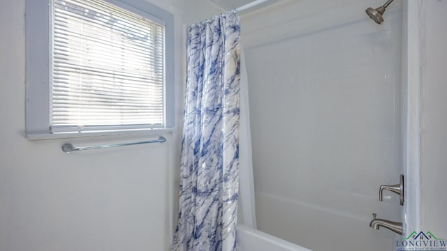 bathroom featuring plenty of natural light and shower / bath combo