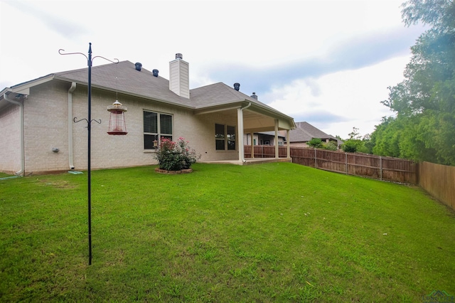 9386 Stonebank Xing, Tyler, TX 75703 - rear view of house with a chimney and a patio