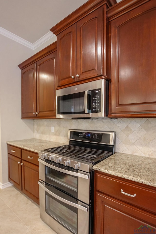 9386 Stonebank Xing, Tyler, TX 75703 - kitchen featuring stainless steel appliances, crown molding, decorative backsplash, light stone countertops, and light tile patterned flooring