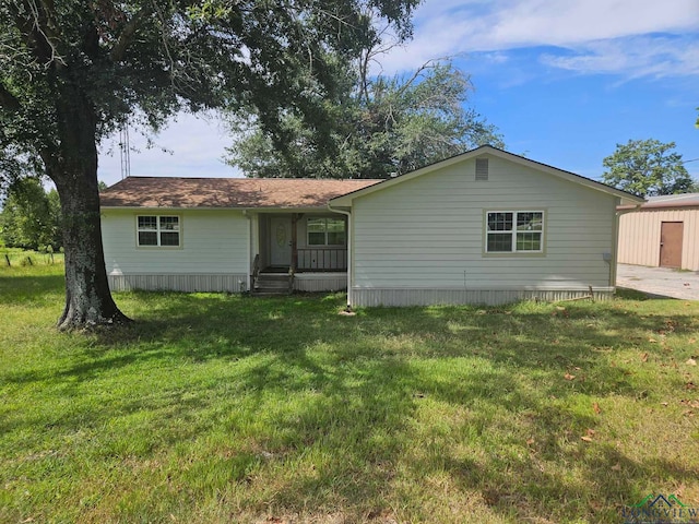 back of property with a porch and a lawn