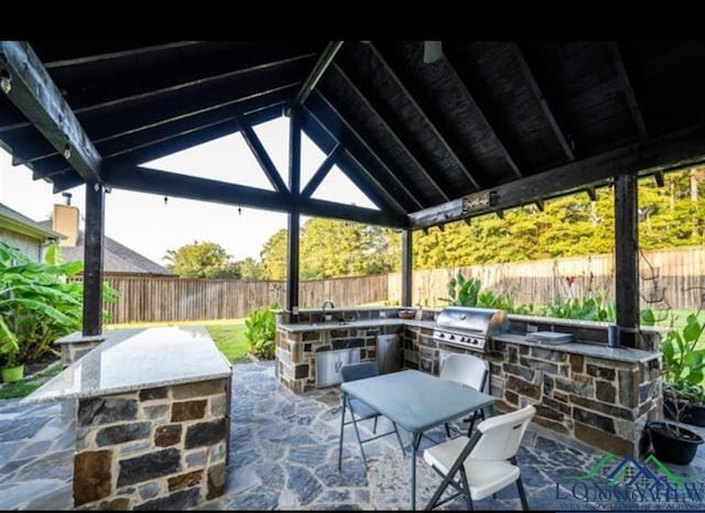 view of patio / terrace featuring a gazebo, area for grilling, a fenced backyard, and a grill