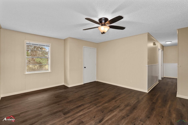 spare room featuring baseboards, a textured ceiling, wood finished floors, and a ceiling fan