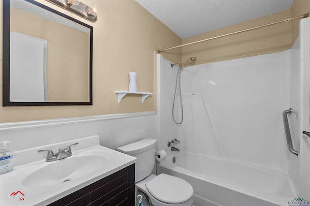 bathroom featuring shower / washtub combination, toilet, a textured ceiling, and vanity