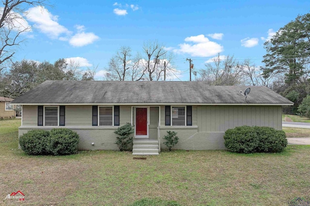 single story home featuring brick siding, a front yard, and entry steps