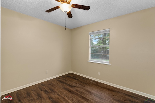 unfurnished room featuring dark wood finished floors, ceiling fan, baseboards, and a textured ceiling