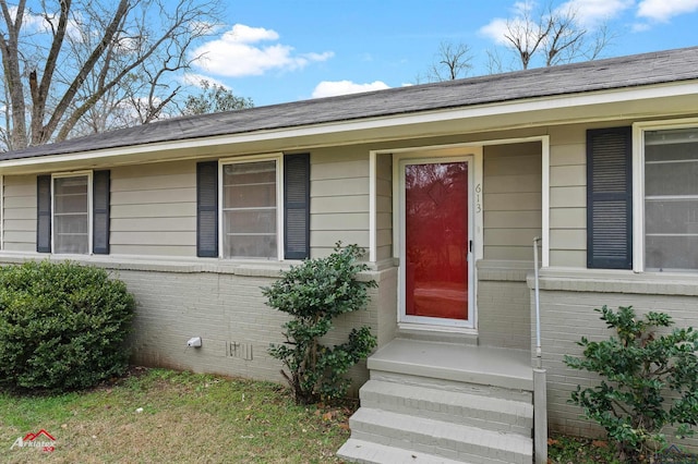 property entrance with crawl space and brick siding