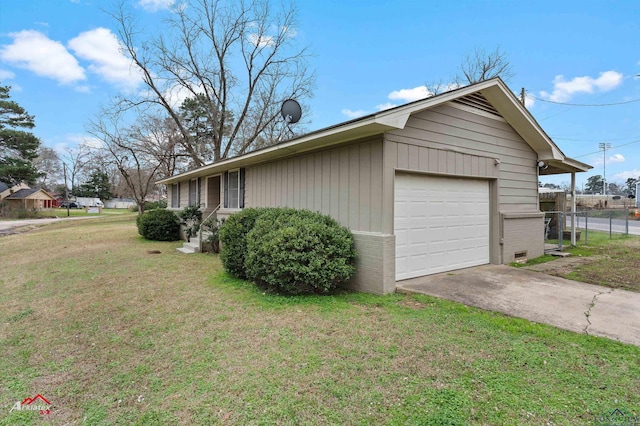 view of side of property featuring concrete driveway, fence, a lawn, and brick siding