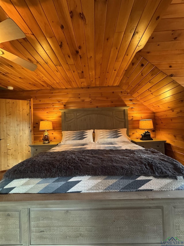 unfurnished bedroom with wood walls and lofted ceiling