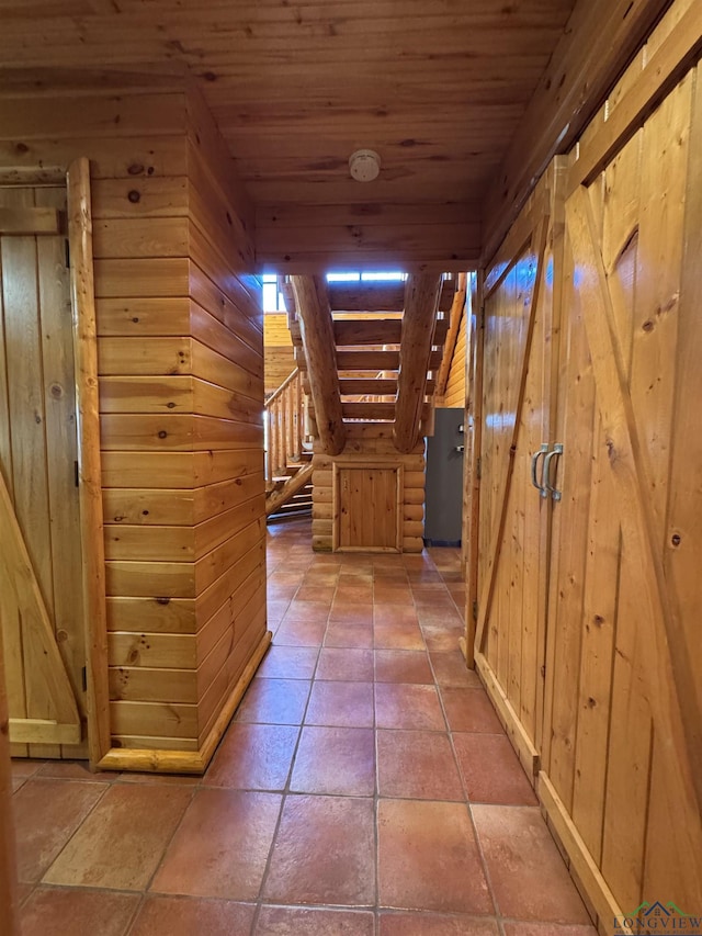 hall with wood ceiling and wood walls