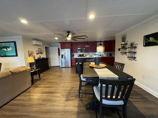 dining space with ceiling fan, sink, a wall mounted AC, wood-type flooring, and ornamental molding