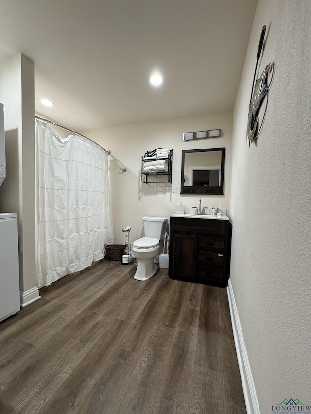 bathroom featuring a shower with curtain, vanity, wood-type flooring, and toilet