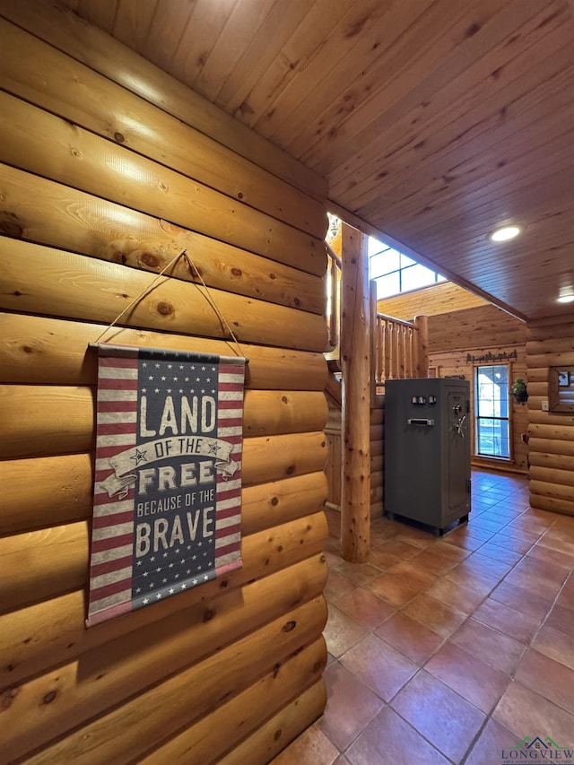 interior space featuring wood ceiling and rustic walls