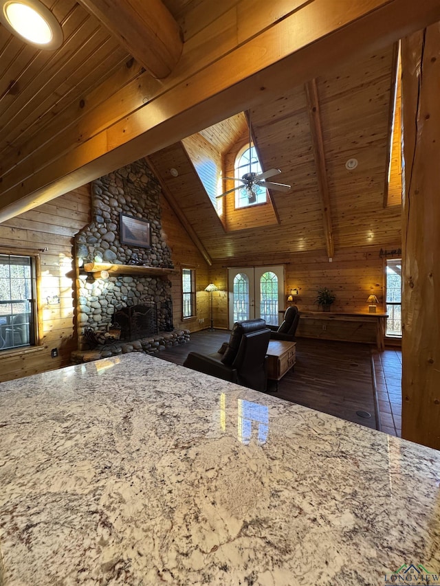 kitchen featuring beam ceiling, a healthy amount of sunlight, and a fireplace