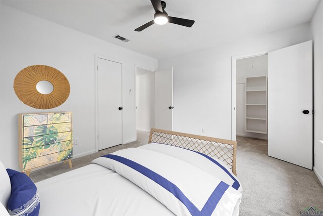 616 Cynthia St, Longview, TX 75605 - bedroom with light colored carpet, ceiling fan, a spacious closet, a closet, and baseboards