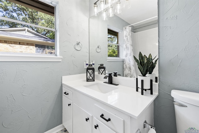 616 Cynthia St, Longview, TX 75605 - bathroom featuring toilet, vanity, a shower with curtain, and a textured wall