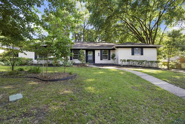 616 Cynthia St, Longview, TX 75605 - ranch-style house with brick siding, a front lawn, and a chimney