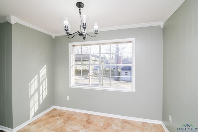 unfurnished dining area with baseboards, crown molding, and an inviting chandelier