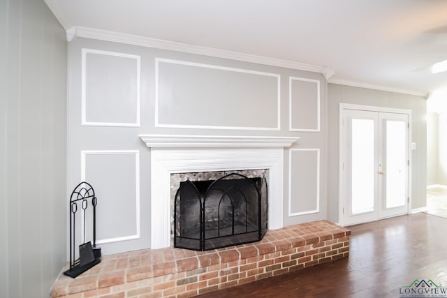 details featuring a fireplace, crown molding, wood finished floors, and french doors