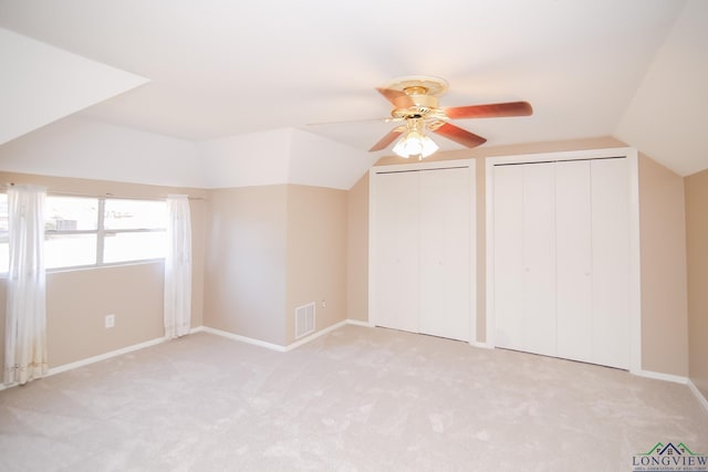 bonus room with vaulted ceiling, carpet flooring, and visible vents