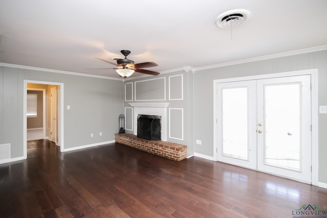 unfurnished living room featuring wood finished floors, visible vents, a fireplace, ornamental molding, and french doors