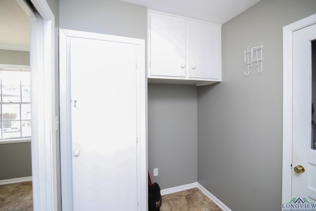 laundry area with baseboards